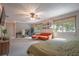Light-filled main bedroom featuring a seating area with large windows and carpeted floors at 1916 River Crossing Dr, Valrico, FL 33596