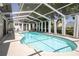Screened-in pool area with a sparkling pool, ample seating, and a relaxing outdoor space at 1916 River Crossing Dr, Valrico, FL 33596