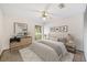 Well-lit bedroom offering a ceiling fan, neutral decor, and a large window for natural light and comfort at 2070 Sunset Point Rd # 111, Clearwater, FL 33765