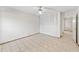 This bedroom has tile floors, a ceiling fan, and a closet with louvered doors at 2070 Sunset Point Rd # 111, Clearwater, FL 33765