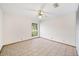 This bedroom has tile floors, a ceiling fan, and a window letting in natural light at 2070 Sunset Point Rd # 111, Clearwater, FL 33765