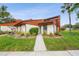 Charming one-story home with beautiful wood accents and a well-maintained front yard at 2070 Sunset Point Rd # 111, Clearwater, FL 33765