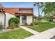 Charming home featuring tidy landscaping, a well-maintained lawn, and a cozy front entry at 2070 Sunset Point Rd # 111, Clearwater, FL 33765