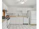 Clean kitchen with white cabinets and tile floors with efficient appliances and ample counter space at 2070 Sunset Point Rd # 111, Clearwater, FL 33765