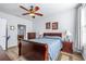 Cozy bedroom featuring a ceiling fan, wood floors, and a warm, inviting atmosphere at 2150 River Turia Cir, Riverview, FL 33578
