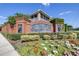Brick entrance to Villa Serena with landscaping, flowers, and shrubs at 2150 River Turia Cir, Riverview, FL 33578