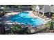 A clear, inviting community pool with lounge chairs and shaded seating for relaxation at 2150 River Turia Cir, Riverview, FL 33578