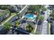 Aerial shot features a community pool, clubhouse, parking, palm trees and manicured landscaping at 2150 River Turia Cir, Riverview, FL 33578
