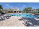 Community pool with a sundeck, lounge chairs, and nearby clubhouse at 2150 River Turia Cir, Riverview, FL 33578