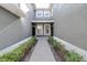Pavered walkway to front door flanked with garden beds filled with greenery and mulch at 2150 River Turia Cir, Riverview, FL 33578