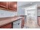 Galley kitchen features a stainless-steel dishwasher, with breakfast nook area and plenty of natural light at 2150 River Turia Cir, Riverview, FL 33578