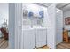 Bright laundry closet featuring a stacked washer and dryer and storage shelf at 2150 River Turia Cir, Riverview, FL 33578