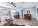 Spacious living room with wood floors and access to dining area and patio at 2150 River Turia Cir, Riverview, FL 33578