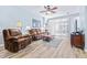 Living room with wood floor and sliding doors to patio at 2150 River Turia Cir, Riverview, FL 33578
