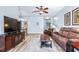 Bright living room with wood flooring and open layout leading to dining area at 2150 River Turia Cir, Riverview, FL 33578