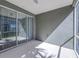 Neutral screened porch with grey walls, carpeted floors, and sliding glass doors at 2150 River Turia Cir, Riverview, FL 33578