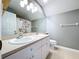 Bathroom with double sink vanity, large mirror, and floral shower curtain at 24314 Landing Dr, Lutz, FL 33559