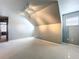 Gray bedroom with a vaulted ceiling, window, and doorway to an adjacent room at 24314 Landing Dr, Lutz, FL 33559