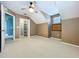 Neutral bedroom featuring a ceiling fan, double window and open closet at 24314 Landing Dr, Lutz, FL 33559
