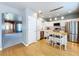 Bright kitchen features stainless appliances, white cabinetry, hardwood floors and a central island with seating at 24314 Landing Dr, Lutz, FL 33559