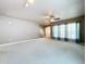 Bright and expansive living room featuring neutral tones, plush carpeting, and large windows at 24314 Landing Dr, Lutz, FL 33559