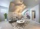 A modern living room featuring a plush sofa, a unique round coffee table, and a well-lit workspace at 24314 Landing Dr, Lutz, FL 33559