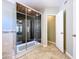 Elegant shower with glass and wood features tile flooring and a neutral color palette at 24314 Landing Dr, Lutz, FL 33559