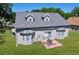 The rear exterior features a patio, sliding glass door, and two bay windows, all overlooking the well maintained lawn at 24314 Landing Dr, Lutz, FL 33559
