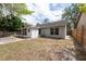 A view of the backyard featuring a screened in porch and partial view of the yard and fence at 2604 Shilo Ct, Valrico, FL 33596