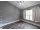 Bedroom boasts new floors, light gray walls, vaulted ceilings, and a large window with curtains at 2604 Shilo Ct, Valrico, FL 33596