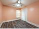 Bedroom featuring peach walls, new floors, a window, and a closet with louvered doors at 2604 Shilo Ct, Valrico, FL 33596