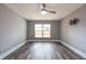Spacious bedroom featuring new floors, gray walls, a ceiling fan and a window with a green backyard view at 2604 Shilo Ct, Valrico, FL 33596