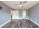 Large bedroom features new floors, ceiling fan, gray walls, a sliding closet door, and access to a bathroom at 2604 Shilo Ct, Valrico, FL 33596