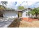 Charming single-story home with a yellow door, manicured front yard, and attached two-car garage at 2604 Shilo Ct, Valrico, FL 33596