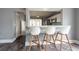 Eat-in Kitchen featuring white bar stools, modern decor, and direct views into kitchen at 2604 Shilo Ct, Valrico, FL 33596