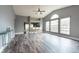 Spacious living room with vaulted ceilings, large windows, and modern wood-look flooring throughout at 2604 Shilo Ct, Valrico, FL 33596