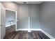 View of empty room with new floors, light gray walls, and open access to other rooms at 2604 Shilo Ct, Valrico, FL 33596
