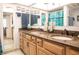 Bathroom vanity featuring double sinks, granite countertops and framed mirrors at 2630 Pearce Dr # 104, Clearwater, FL 33764