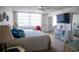 Bedroom with a queen bed, ceiling fan, and a sliding mirror door closet at 2630 Pearce Dr # 104, Clearwater, FL 33764
