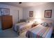 Bright bedroom featuring two twin beds with colorful bedding and a dresser at 2630 Pearce Dr # 104, Clearwater, FL 33764