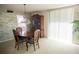 Dining room with wood furniture, green wallpaper, and large bright window at 2630 Pearce Dr # 104, Clearwater, FL 33764