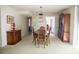 Dining room with wood furniture, green wallpaper, and large china cabinet at 2630 Pearce Dr # 104, Clearwater, FL 33764