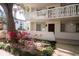Condo exterior featuring a private balcony, well-maintained landscaping, and charming architectural details at 2630 Pearce Dr # 104, Clearwater, FL 33764