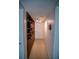 Hallway featuring built-in bookcase and neutral carpet at 2630 Pearce Dr # 104, Clearwater, FL 33764