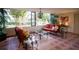 Cozy living room with large windows offering serene views, comfortable seating and decorative wrought iron accents at 2630 Pearce Dr # 104, Clearwater, FL 33764