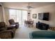 Bright living room featuring sliding glass doors and comfortable seating at 2630 Pearce Dr # 104, Clearwater, FL 33764
