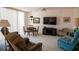 Cozy living room with natural light, comfortable seating, and adjacent dining area at 2630 Pearce Dr # 104, Clearwater, FL 33764