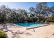 Community pool with an abundance of lounge chairs for relaxation at 2630 Pearce Dr # 104, Clearwater, FL 33764