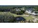 Aerial view of golf course with a pond and trees around white condos at 29909 Baywood Ln, Wesley Chapel, FL 33543