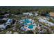 Aerial view of community with large pool, water feature, clubhouse, and lush landscaping at 29909 Baywood Ln, Wesley Chapel, FL 33543